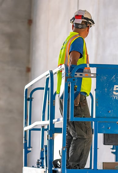 Worker running a scissor lift