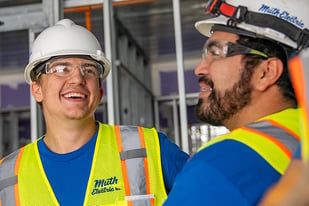 Two workers smiling and talking