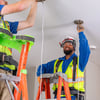 Electricians installing lights
